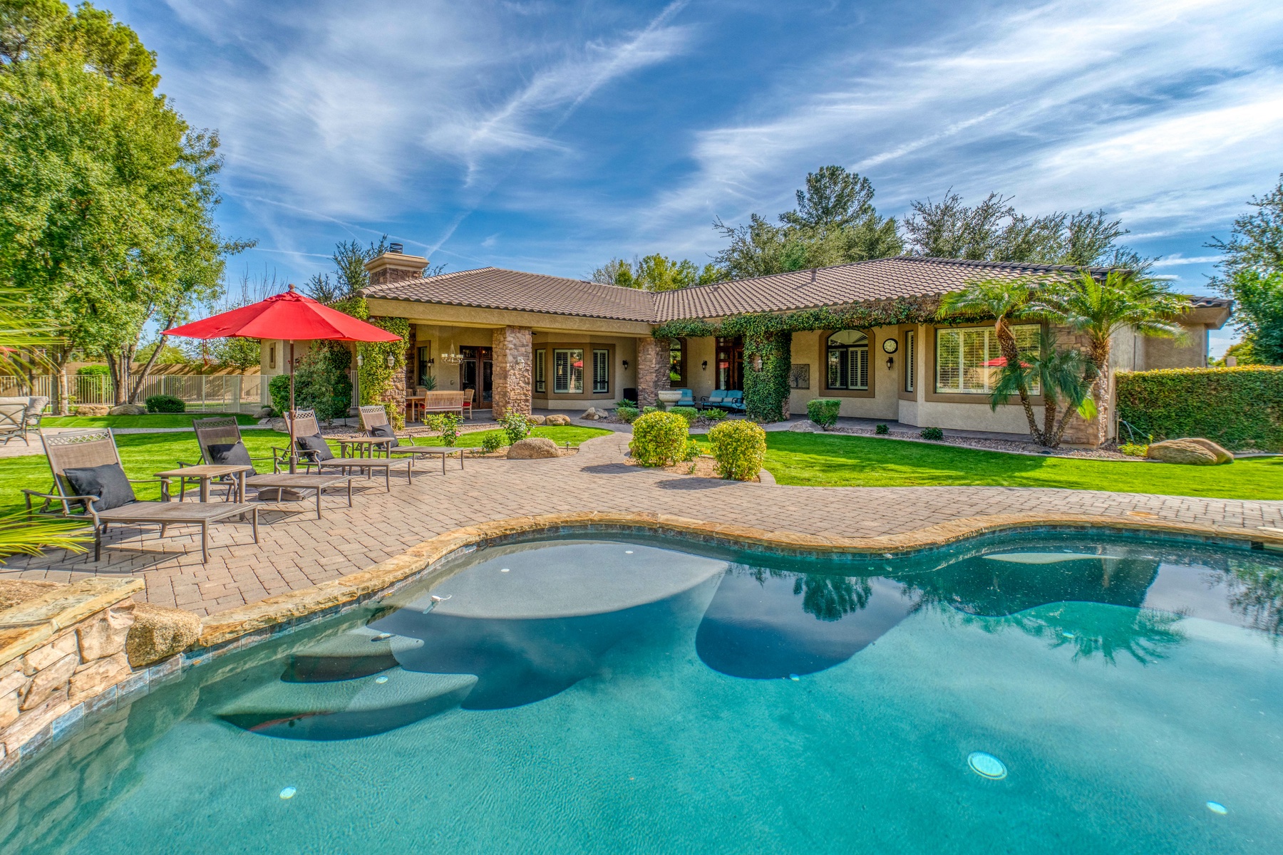 A vacation rental with a large outdoor pool. 