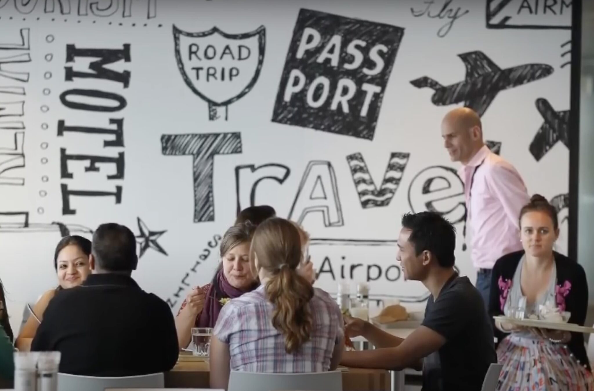 Booking.com employees having a meal together. 