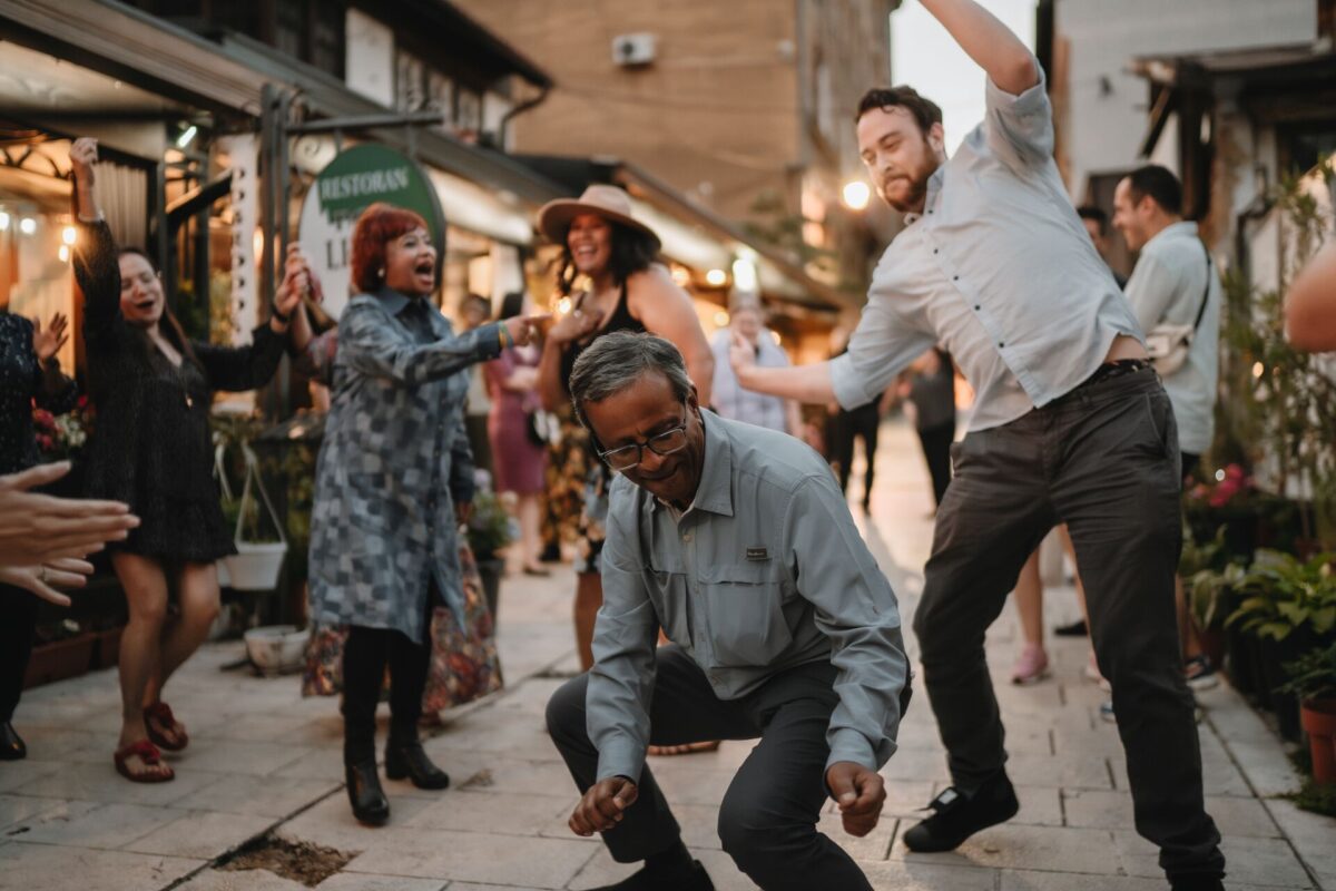 Trafalgar guests attempt Sribash dancing at a traditional Bosnian dinner.